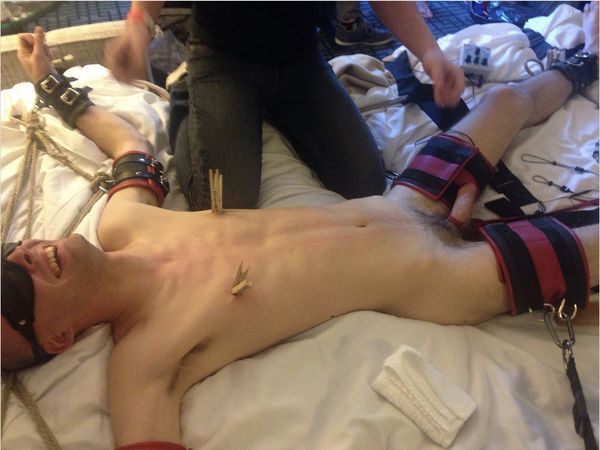 Image of me, blindfolded and tied a bed with leather and rope. I am in the middle of being tormented.